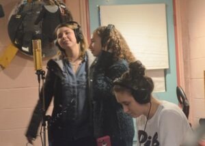 Sierra and Sarah practice backing vocals around the Lawson L-47 microphone